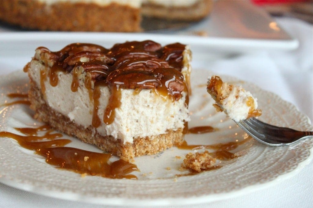slice of pecan pie cheesecake with a bite taken out of it