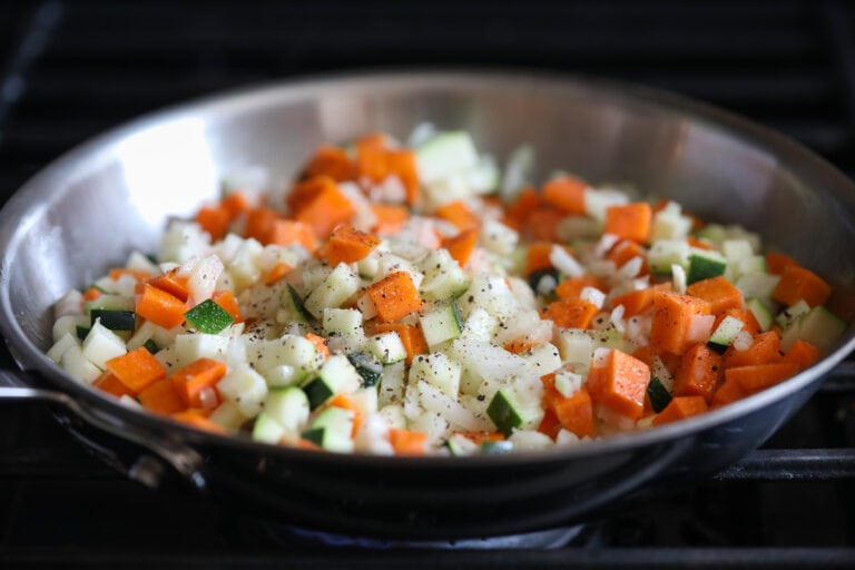 onion, carrot and zucchini in skillet