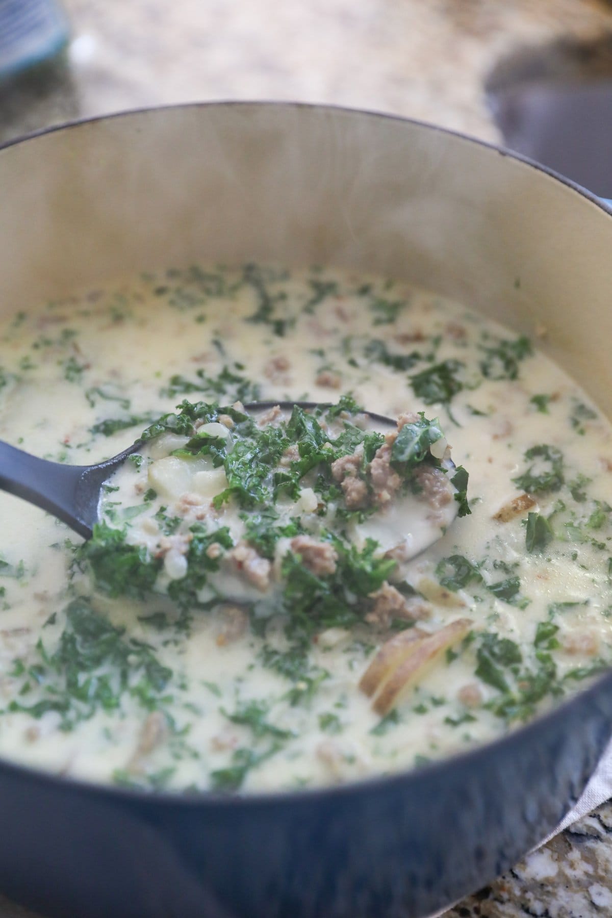 sausage kale soup in blue pot