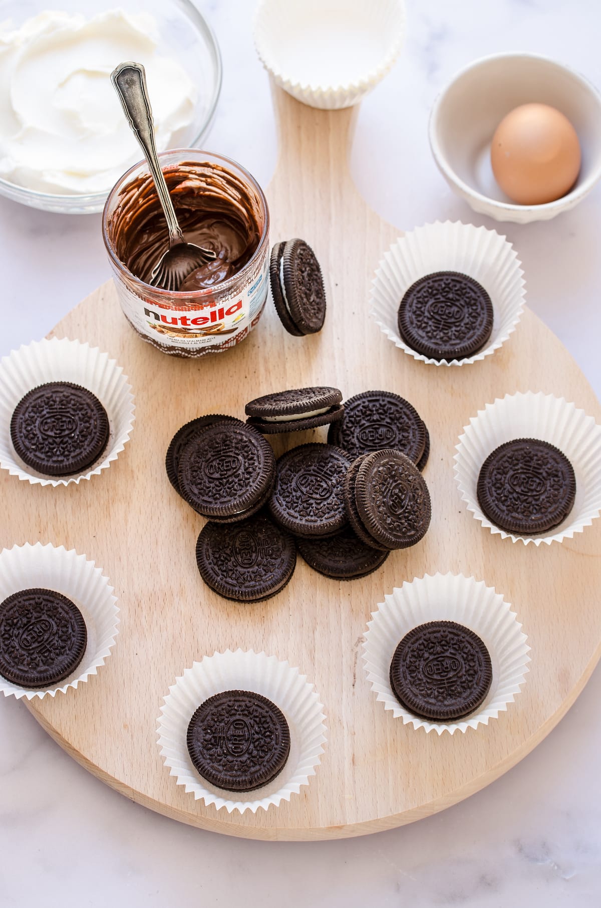 Overhead view of Oreos in cupcake liners and a pile of Oreos in the middle