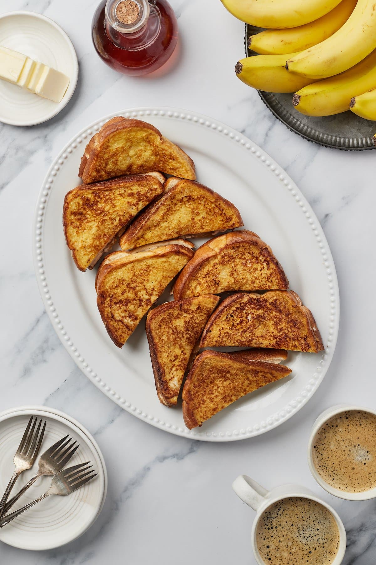 Stuffed french toast, sliced on the diagonal and arranged on a white serving platter.
