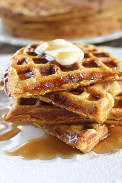 Stack of healthy pumpkin waffles with butter and syrup