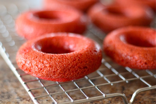 Red Velvet Donuts unfrosted on a cooling wrack