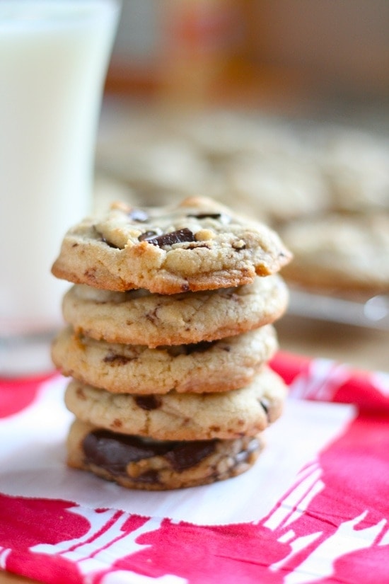 Dark Chocolate Chunk Cookies stacked on top of each other on a napkin