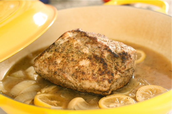 Pork cooking in a pan with other ingredients