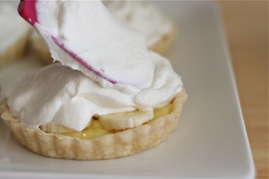 spreading whipping cream on pie