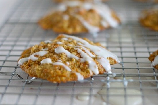 oatmeal breakfast cookies on a cooling wrack with frosting drizzled on top