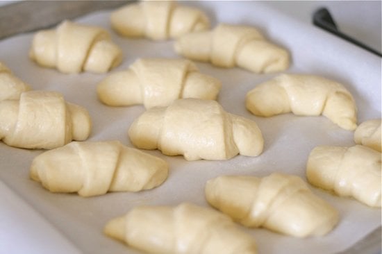 risen crescent rolls on a baking sheet