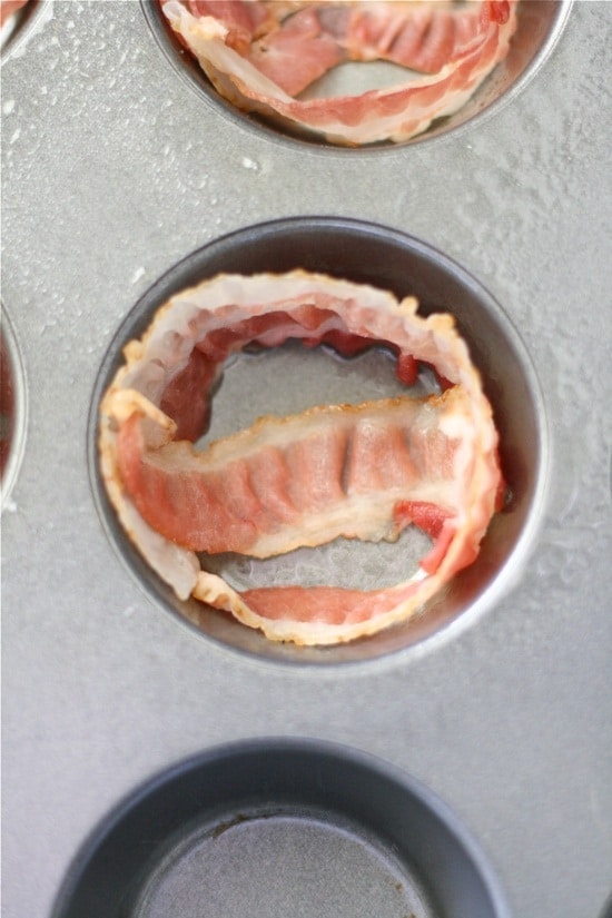 Muffin tin lined with bacon