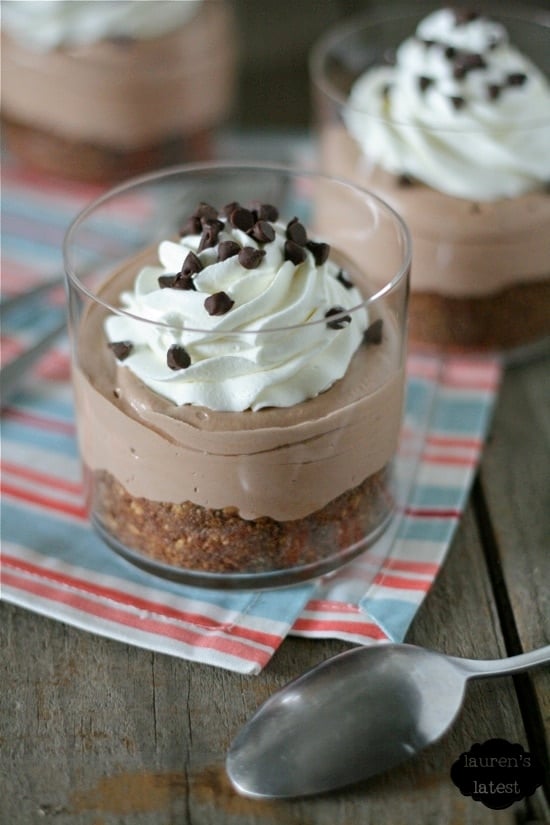 No-Bake Brownie Batter Cheesecake in a plastic cup with whipped cream on top