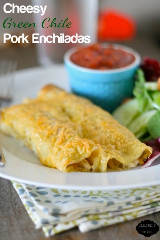 pork enchiladas on a white plate with words over the image saying 'cheesy green chile pork enchiladas'