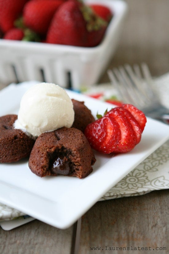  Mini Chocolate Lava Cakes on a plate with ice cream and sliced strawberries