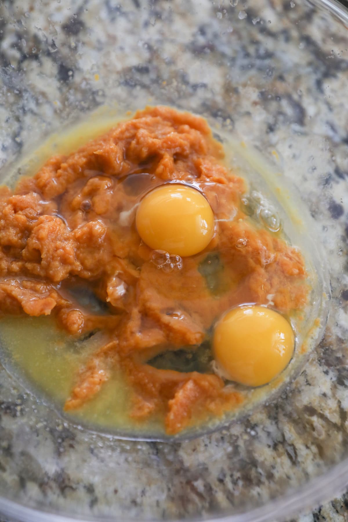 pumpkin, eggs and melted butter in glass bowl