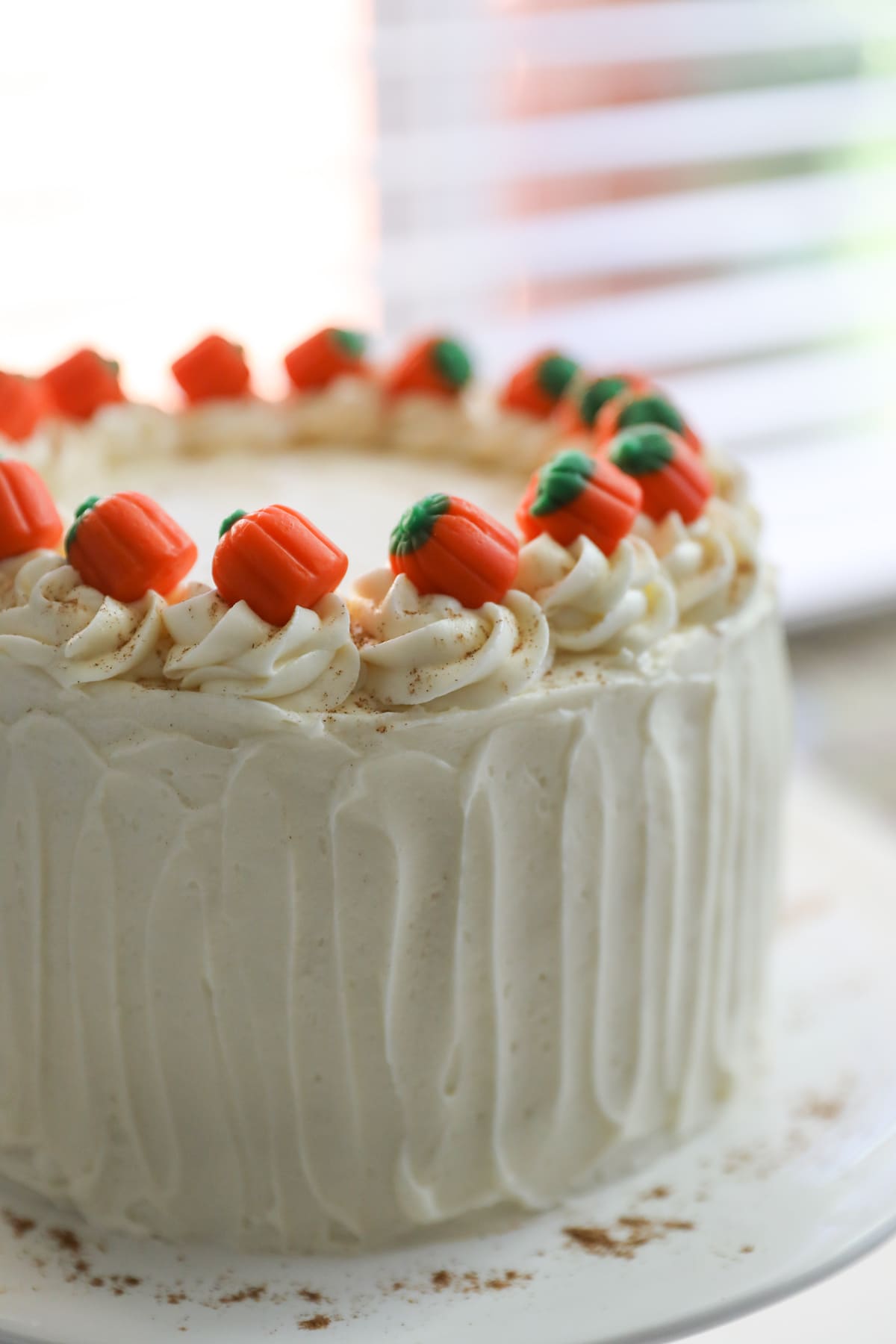 pumpkin cheesecake cake on white cake stand
