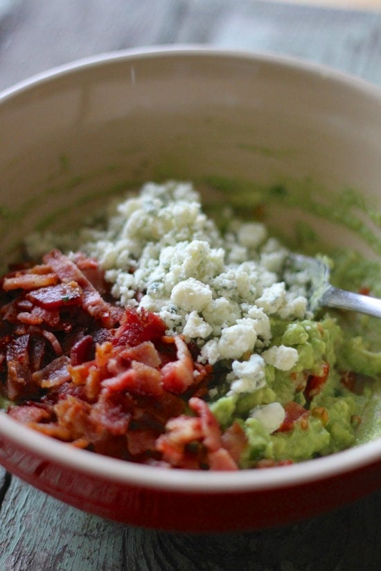 Ingredients in a red bowl premixed into the guacamole
