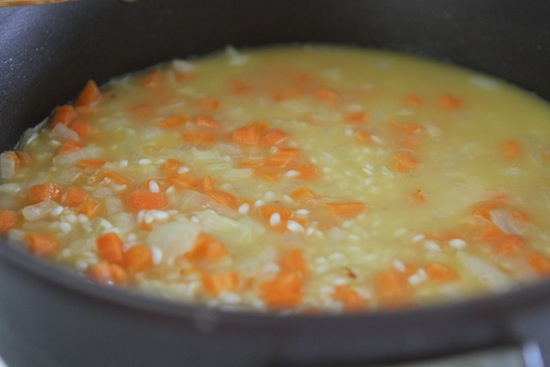 cooking rice and carrots in broth