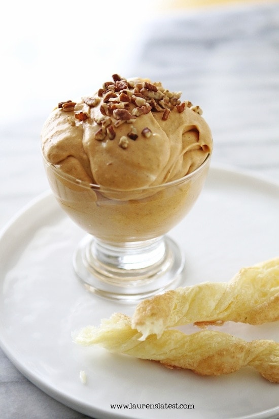 pumpkin butterscotch dip in a glass on a plate with twists