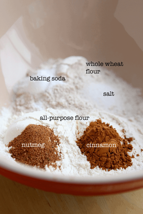 dry ingredients in a bowl labeled (baking soda, whole wheat flour, salt, cinnamon, nutmeg and all purpose flour)