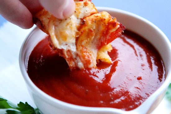 dipping a pizza knot in marinara sauce