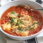 tomato basil tortellini soup in white bowl