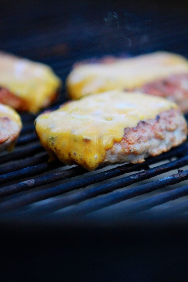 turkey burgers with cheese on grill
