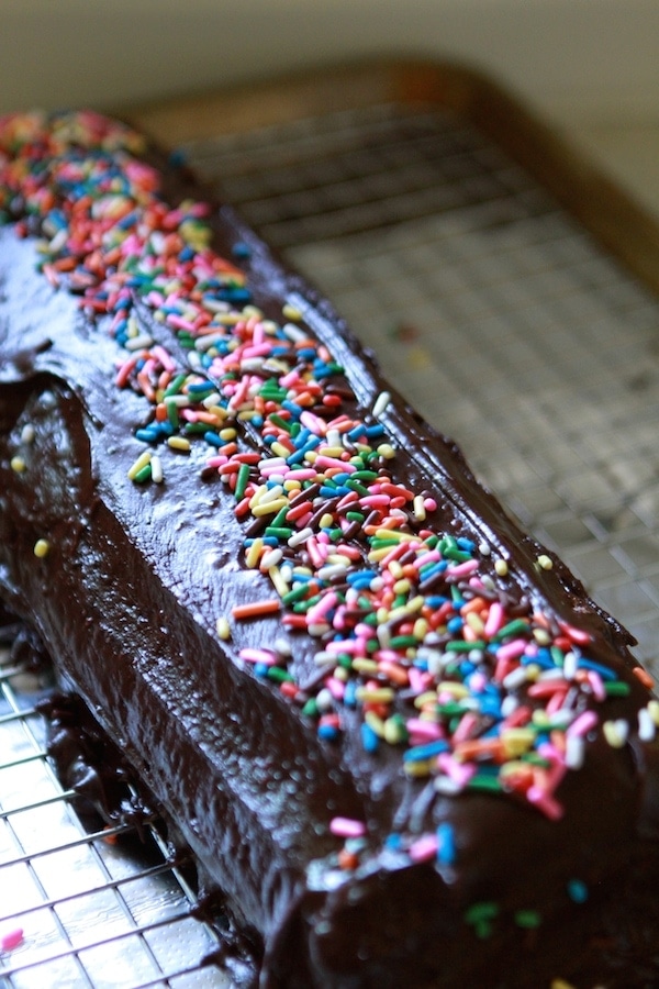 sprinkles on a glazed swiss roll cake