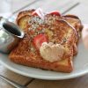 french toast with butter, powdered sugar and strawberries
