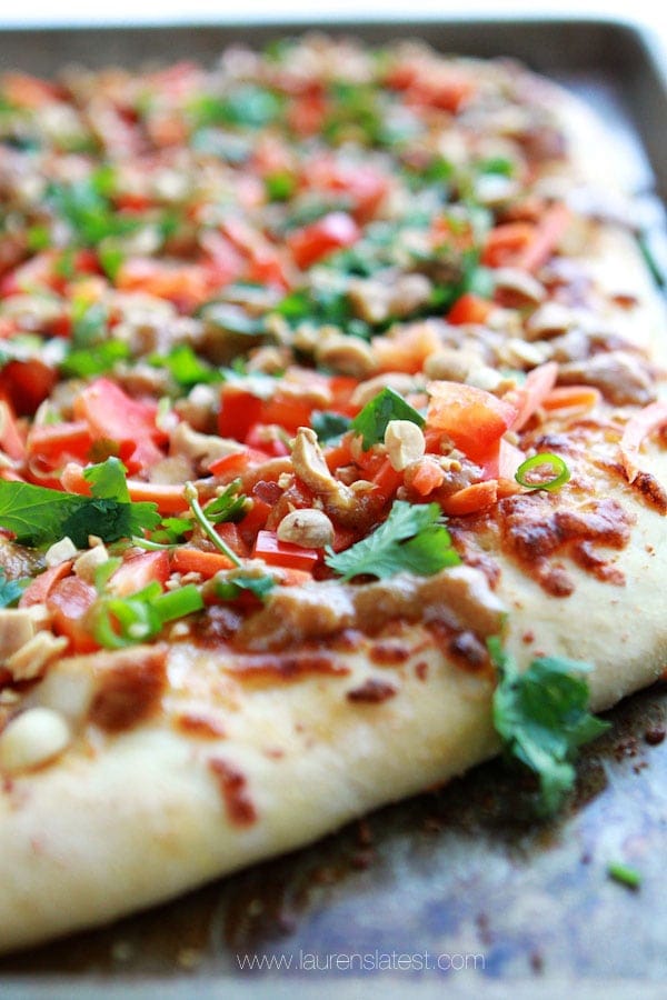 close up of thai pizza with toppings on it