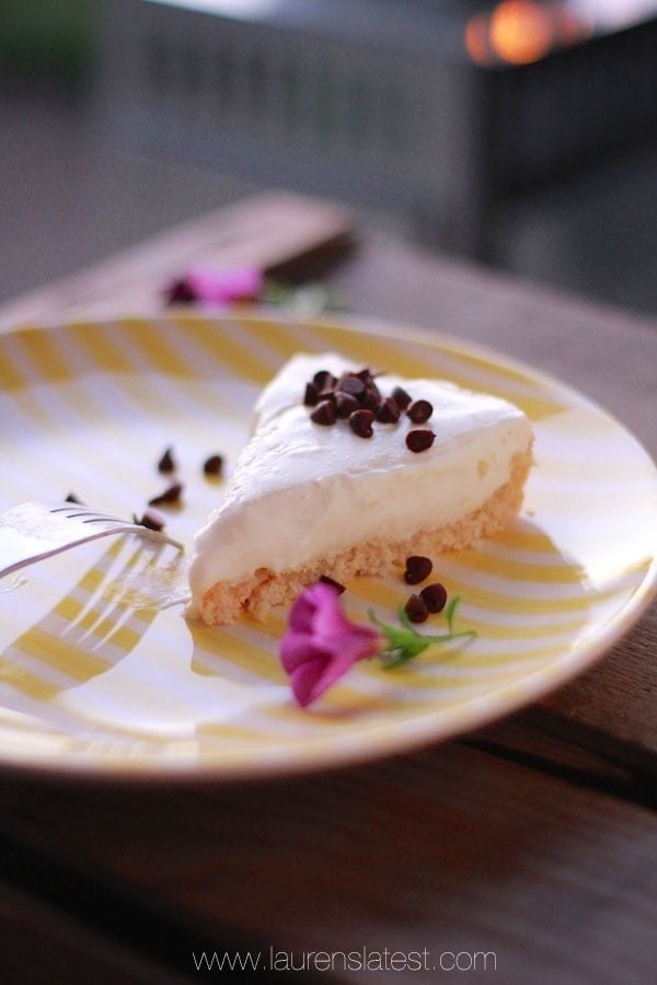 slice of protein cheesecake on a white and yellow striped plate
