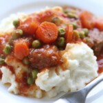 swiss steak and mashed potatoes in a bowl