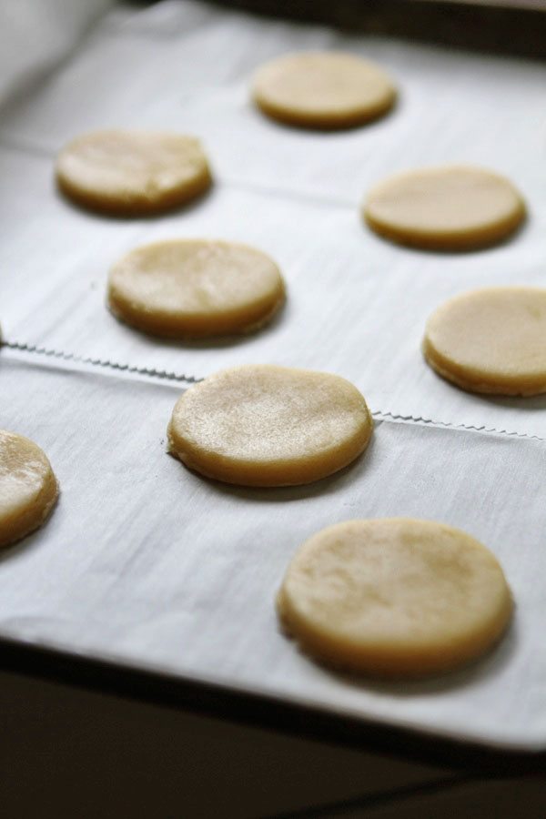 cut out sugar cookies on a parchment paper lined baking sheet