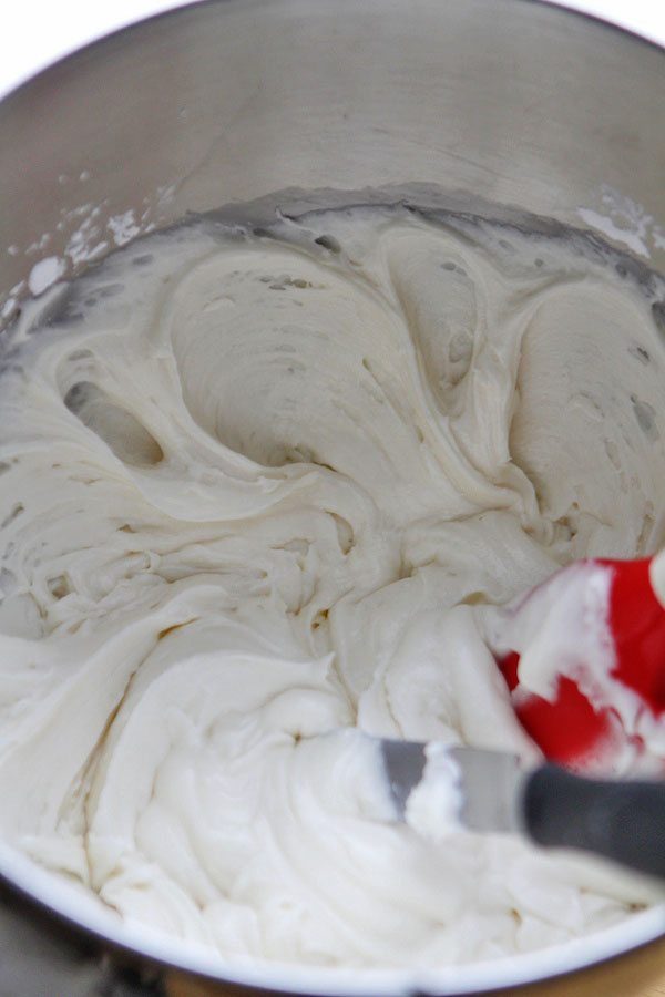 buttercream frosting in a metal bowl with a spatula