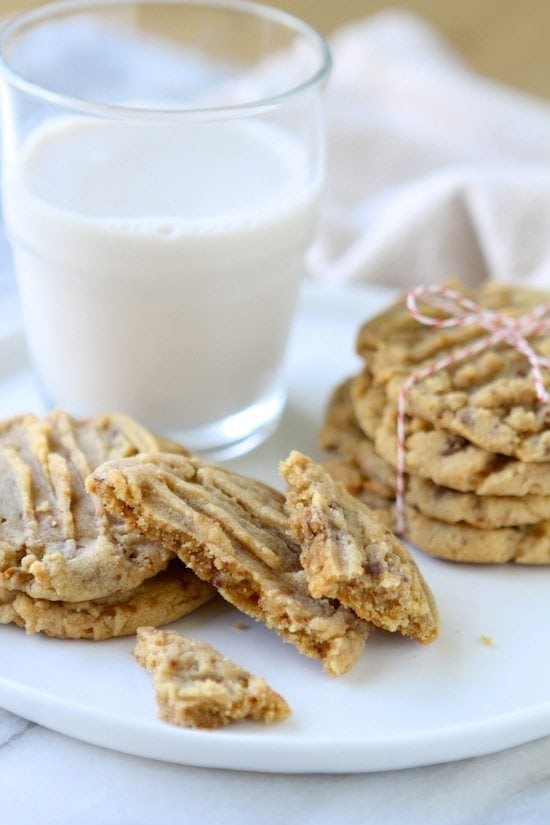 peanut butter toffee cookies on a plate with milk