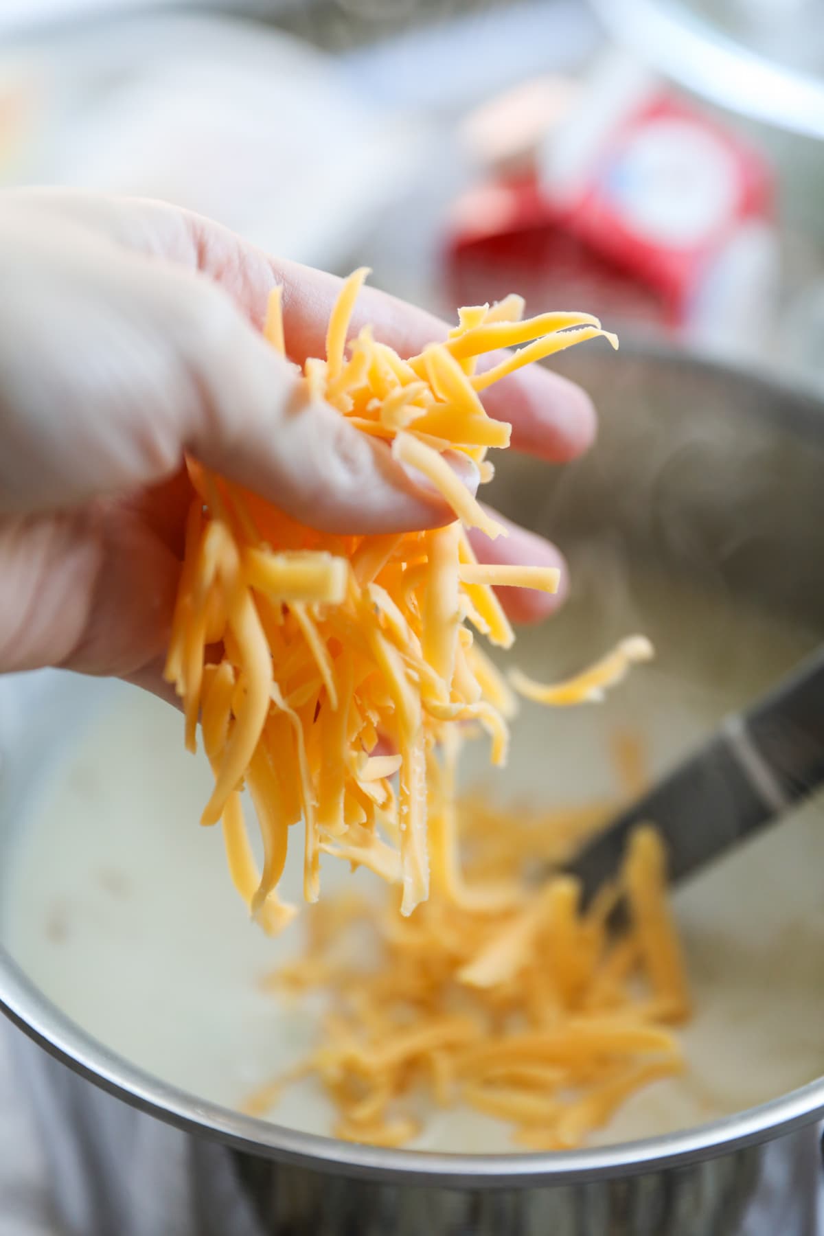 sprinkling cheese into soup