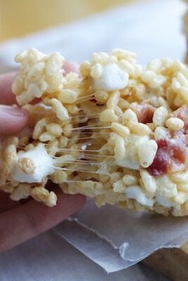 A person holding a piece of Maple Bacon Rice Krispie Treats.