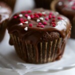 Chocolate Zucchini Cupcakes with sprinkles on a white plate.