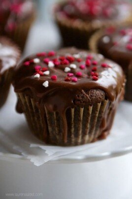 Chocolate Zucchini Cupcakes with sprinkles on a white plate.
