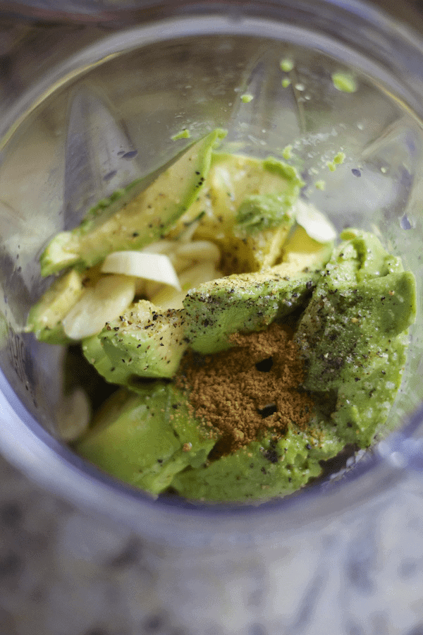Charred Tomatillo Avocado Dressing unmixed in a blender