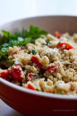 A bowl of Mediterranean Quinoa Salad with tomatoes and parsley.