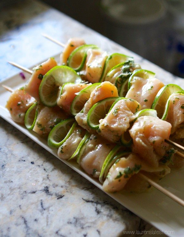 A plate of uncooked chicken skewers