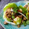 Asian chicken lettuce wraps with vegetables on a plate.