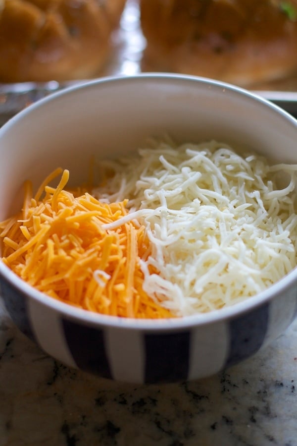 Two types of cheese in a bowl shredded