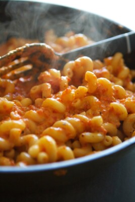 Macaroni and cheese in a skillet with a fork.