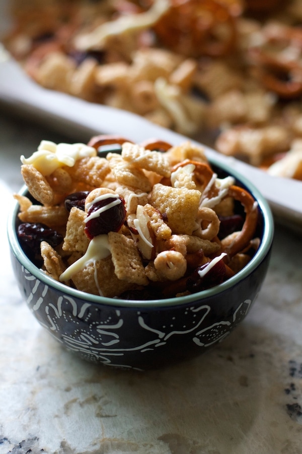 A bowl of cheesy granola with nuts and pretzels, perfect for snacking.