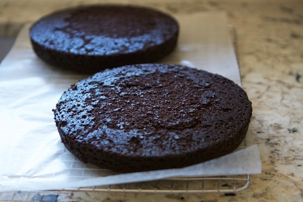 two chocolate cake rounds on parchment paper