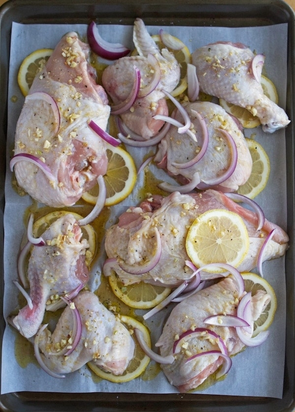 Raw chicken, lemon sliced and red onion