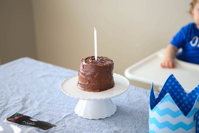 Chocolate birthday cake with one candle in it