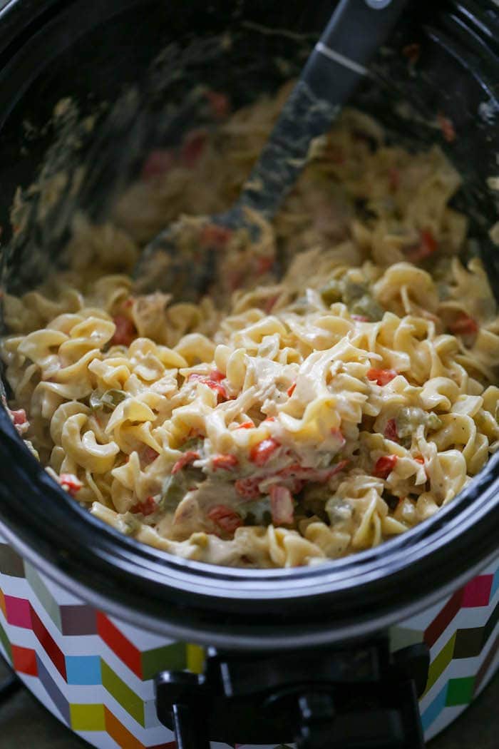 Southwest Crockpot Egg Noodle Casserole is a creamy and easy Mexican inspired chicken dinner! Filled with peppers, cream cheese, chicken and lots of egg noodles, this meal is totally family-friendly and kid approved.