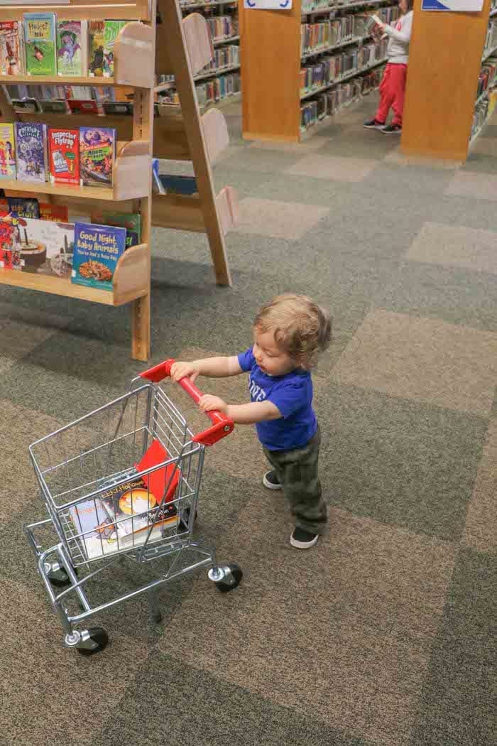 Eddie pushing a mini shopping cart