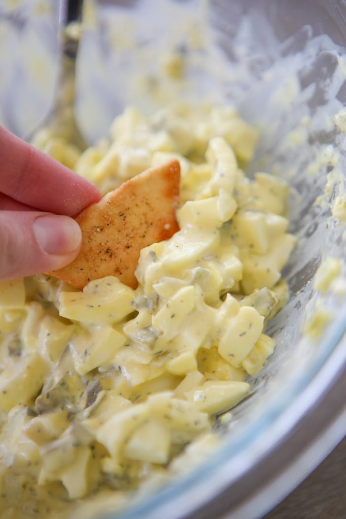 dipping a chip into healthy egg salad